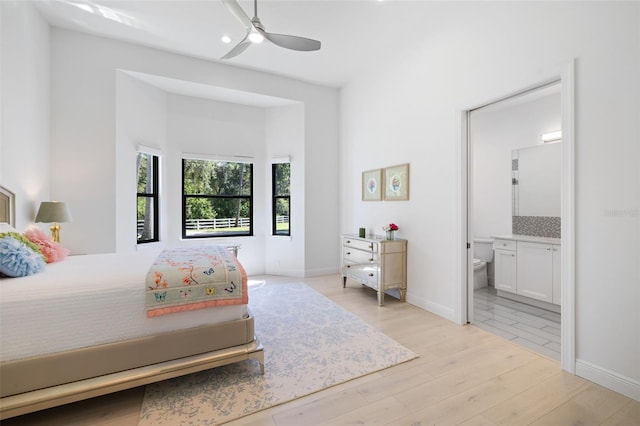 7051 Turtle Ln, Sarasota, FL 34241 - bedroom with light wood-style floors, connected bathroom, and a ceiling fan