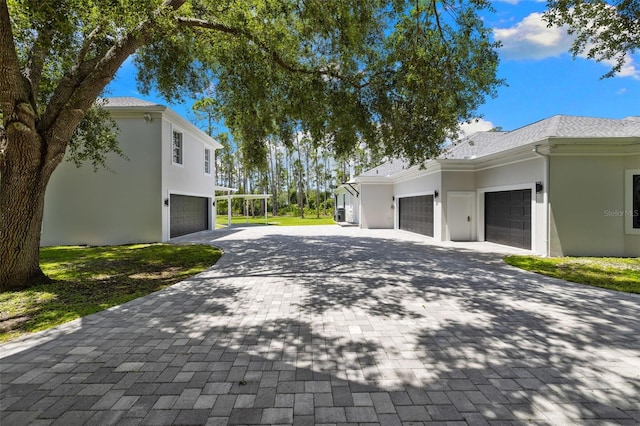 7051 Turtle Ln, Sarasota, FL 34241 - view of side of property featuring decorative driveway, stucco siding, and an attached garage