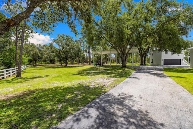 7051 Turtle Ln, Sarasota, FL 34241 - view of yard featuring driveway and a garage