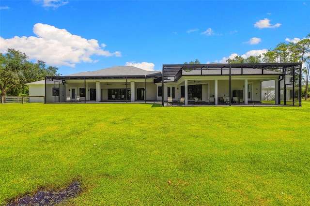 7051 Turtle Ln, Sarasota, FL 34241 - back of house featuring ceiling fan, a yard, and a patio