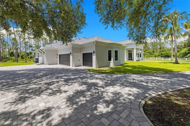 7051 Turtle Ln, Sarasota, FL 34241 - view of property exterior with an attached garage, stucco siding, and decorative driveway