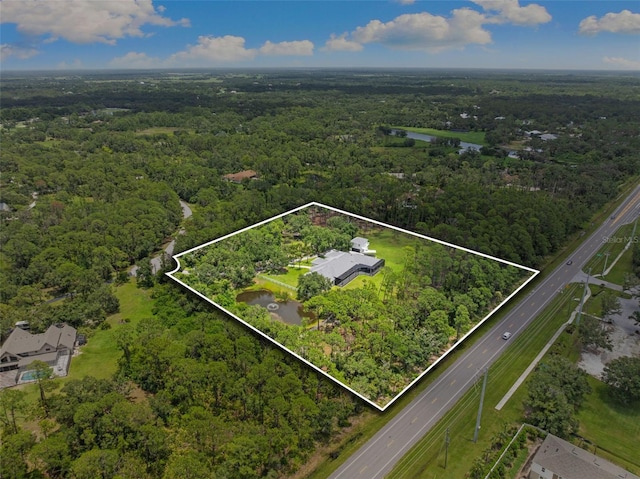 7051 Turtle Ln, Sarasota, FL 34241 - aerial view of property and surrounding area featuring a heavily wooded area and property boundaries highlighted