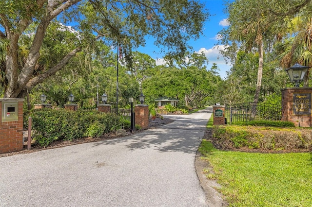7051 Turtle Ln, Sarasota, FL 34241 - view of asphalt driveway with street lighting