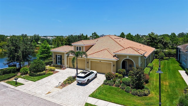 11603 Bluebird Pl, Lakewood Ranch, FL 34211 - mediterranean / spanish-style home with a garage, a tiled roof, stucco siding, decorative driveway, and a front yard