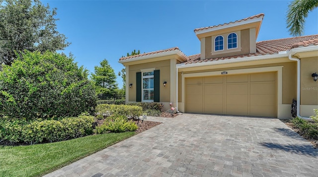 11603 Bluebird Pl, Lakewood Ranch, FL 34211 - view of front of home with stucco siding, a tiled roof, and decorative driveway