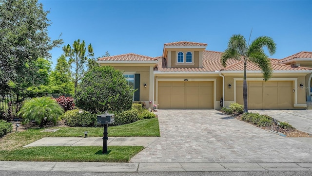 11603 Bluebird Pl, Lakewood Ranch, FL 34211 - view of front of house featuring stucco siding, a garage, and a tile roof