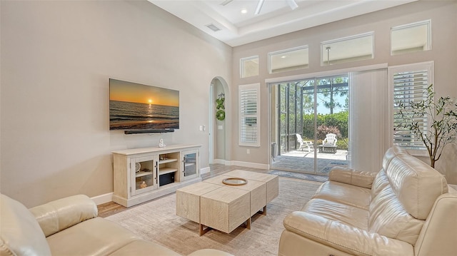 11603 Bluebird Pl, Lakewood Ranch, FL 34211 - living room with baseboards, arched walkways, a high ceiling, light wood-style floors, and recessed lighting