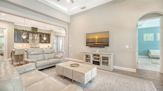 11603 Bluebird Pl, Lakewood Ranch, FL 34211 - living room with arched walkways, light wood-type flooring, baseboards, recessed lighting, and a ceiling fan