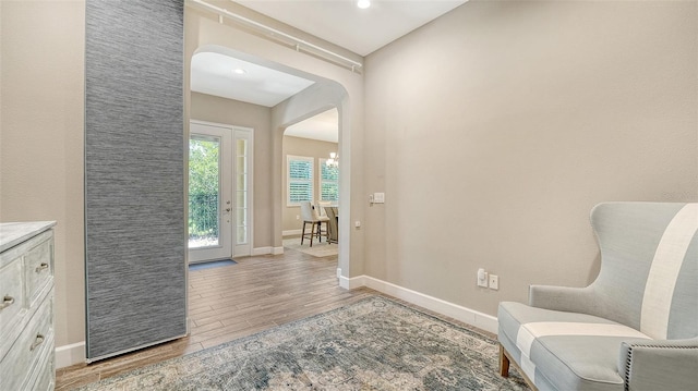 11603 Bluebird Pl, Lakewood Ranch, FL 34211 - living area featuring light wood finished floors, arched walkways, baseboards, and recessed lighting