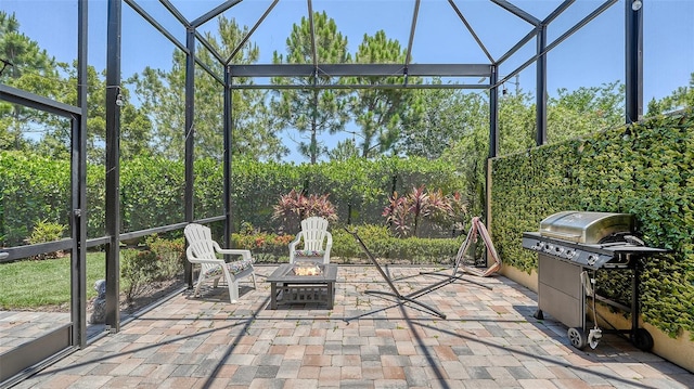 11603 Bluebird Pl, Lakewood Ranch, FL 34211 - view of patio / terrace with glass enclosure, area for grilling, and a fire pit