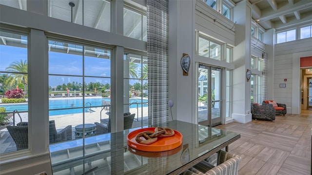 11603 Bluebird Pl, Lakewood Ranch, FL 34211 - dining room with a high ceiling, plenty of natural light, beamed ceiling, and baseboards