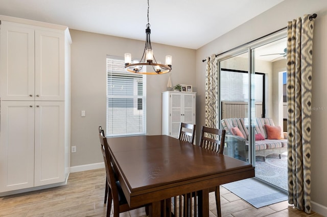 11411 Spring Gate Trl, Bradenton, FL 34211 - dining room featuring light wood-style floors, a chandelier, and baseboards