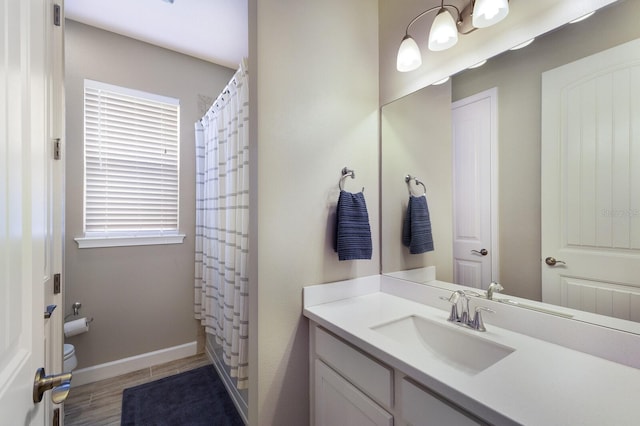 11411 Spring Gate Trl, Bradenton, FL 34211 - full bathroom featuring vanity, toilet, baseboards, a shower with shower curtain, and wood finished floors