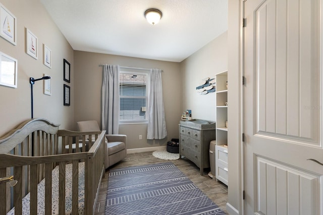 11411 Spring Gate Trl, Bradenton, FL 34211 - bedroom with light wood-style flooring, a nursery area, and baseboards