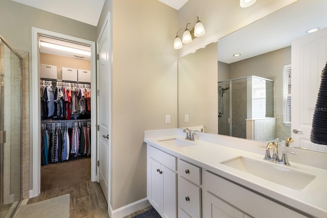 11411 Spring Gate Trl, Bradenton, FL 34211 - bathroom featuring a shower stall, a walk in closet, and double vanity