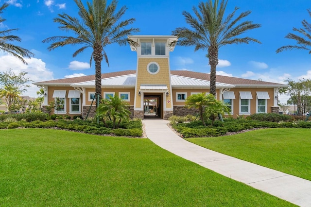11411 Spring Gate Trl, Bradenton, FL 34211 - view of front of house with stone siding, a front lawn, and a standing seam roof