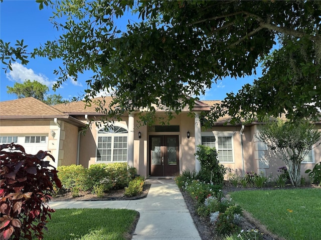 3192 Oaks Bnd, Bowling Green, FL 33834 - view of front of property with french doors, stucco siding, and a front lawn