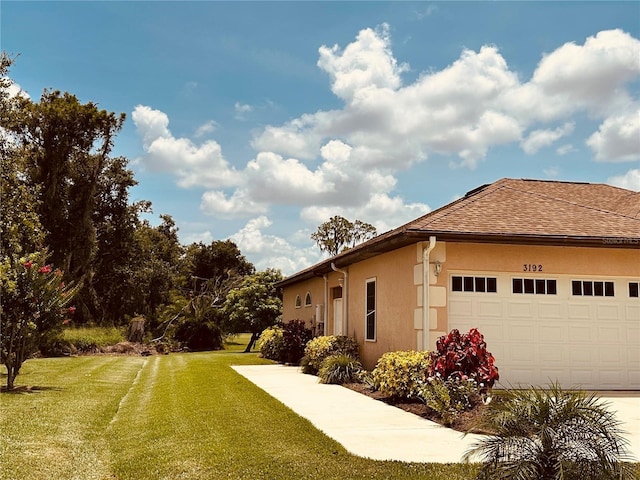 3192 Oaks Bnd, Bowling Green, FL 33834 - view of side of property with a yard, stucco siding, an attached garage, and a shingled roof