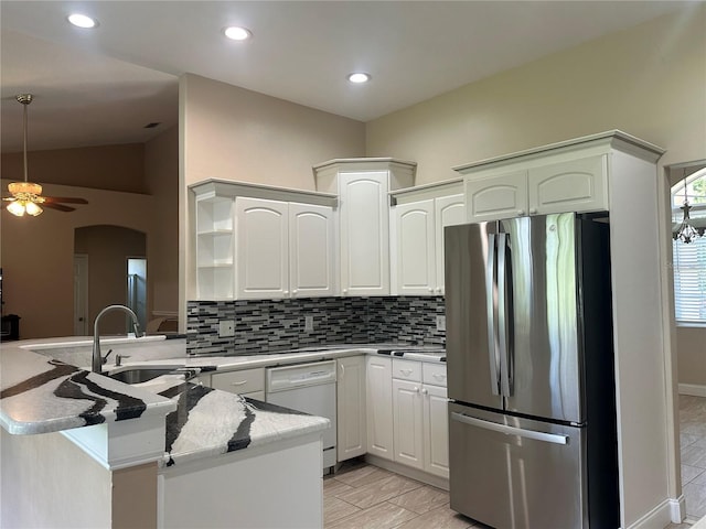 3192 Oaks Bnd, Bowling Green, FL 33834 - kitchen with freestanding refrigerator, white dishwasher, a peninsula, tasteful backsplash, and recessed lighting