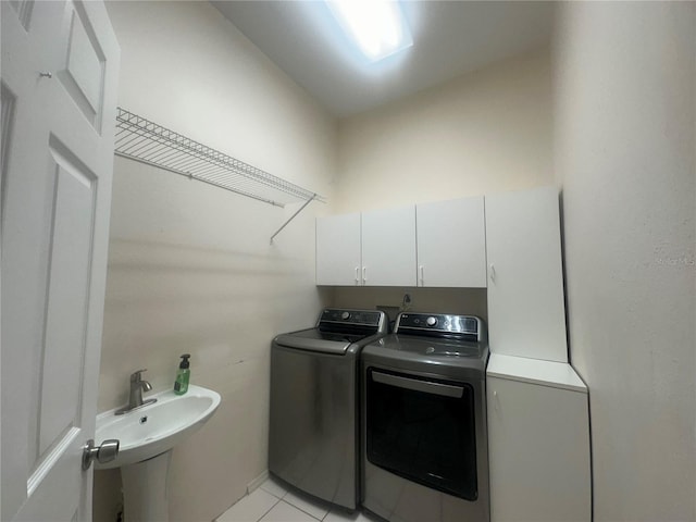3192 Oaks Bnd, Bowling Green, FL 33834 - laundry room featuring independent washer and dryer, cabinet space, and light tile patterned floors