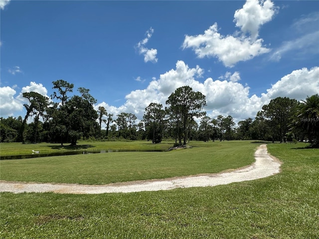 3192 Oaks Bnd, Bowling Green, FL 33834 - surrounding community with a lawn, a water view, and view of scattered trees