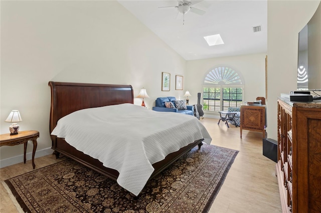 7331 Villa D Este Dr, Sarasota, FL 34238 - bedroom with a skylight, light wood-style floors, high vaulted ceiling, ceiling fan, and baseboards