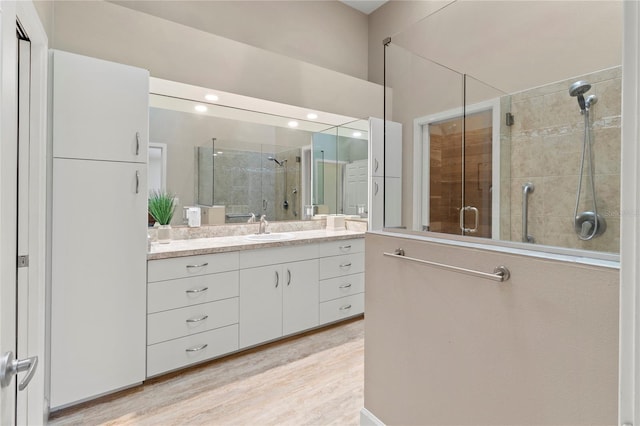 7331 Villa D Este Dr, Sarasota, FL 34238 - bathroom with a stall shower, vanity, and wood finished floors