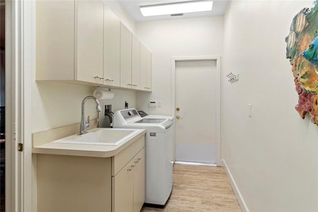 7331 Villa D Este Dr, Sarasota, FL 34238 - laundry area with separate washer and dryer, cabinet space, light wood finished floors, and baseboards