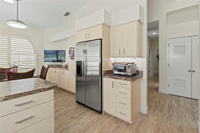 7331 Villa D Este Dr, Sarasota, FL 34238 - kitchen featuring stainless steel fridge with ice dispenser, high vaulted ceiling, light wood finished floors, and hanging light fixtures