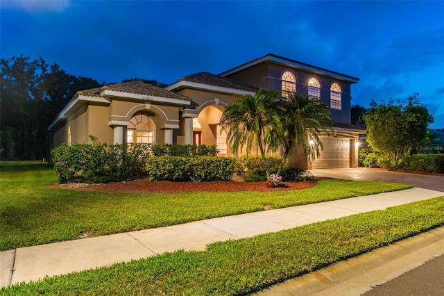 9008 Brookfield Ter, Bradenton, FL 34212 - mediterranean / spanish home with concrete driveway, stucco siding, a garage, and a yard