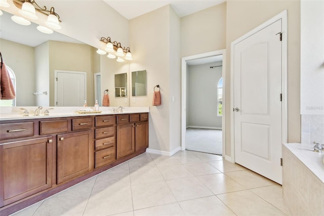 9008 Brookfield Ter, Bradenton, FL 34212 - full bath with double vanity, tiled tub, baseboards, and tile patterned flooring