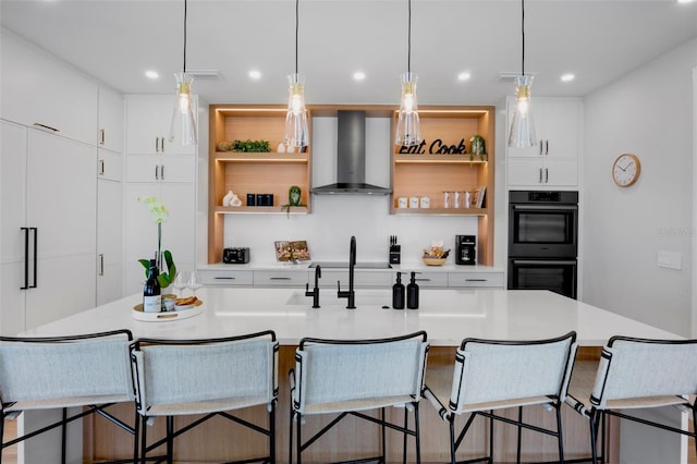 103 4th St N Unit A, Bradenton Beach, FL 34217 - kitchen with wall chimney exhaust hood, open shelves, light countertops, decorative light fixtures, and recessed lighting