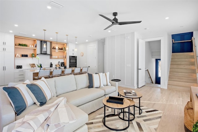 103 4th St N Unit A, Bradenton Beach, FL 34217 - living room featuring stairs, ceiling fan, recessed lighting, baseboards, and light wood-type flooring