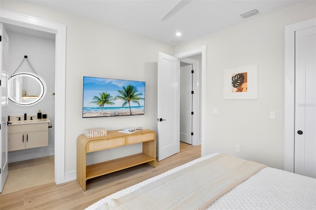 103 4th St N Unit A, Bradenton Beach, FL 34217 - bedroom featuring light wood-style flooring, recessed lighting, ensuite bathroom, and baseboards