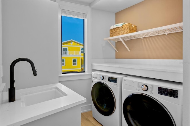 103 4th St N Unit A, Bradenton Beach, FL 34217 - washroom featuring washer and clothes dryer and light wood-style floors
