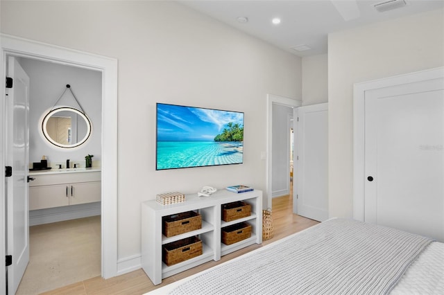 103 4th St N Unit A, Bradenton Beach, FL 34217 - bedroom featuring light wood-type flooring, baseboards, recessed lighting, and a sink