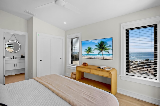 103 4th St N Unit A, Bradenton Beach, FL 34217 - bedroom featuring light wood-style flooring, lofted ceiling, a sink, a ceiling fan, and ensuite bathroom