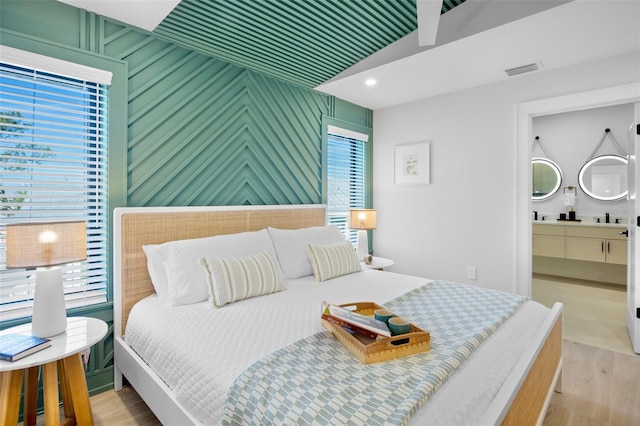 103 4th St N Unit A, Bradenton Beach, FL 34217 - bedroom featuring light wood-style flooring and a sink