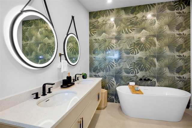 103 4th St N Unit A, Bradenton Beach, FL 34217 - full bathroom featuring wallpapered walls, a soaking tub, double vanity, and an accent wall