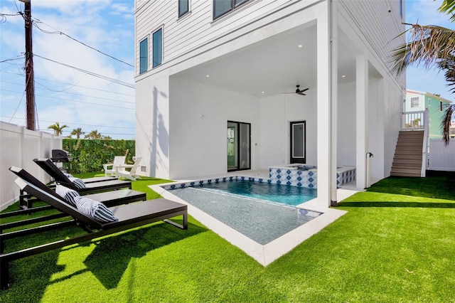 103 4th St N Unit A, Bradenton Beach, FL 34217 - rear view of property with a ceiling fan, an outdoor pool, a patio, stucco siding, and stairs