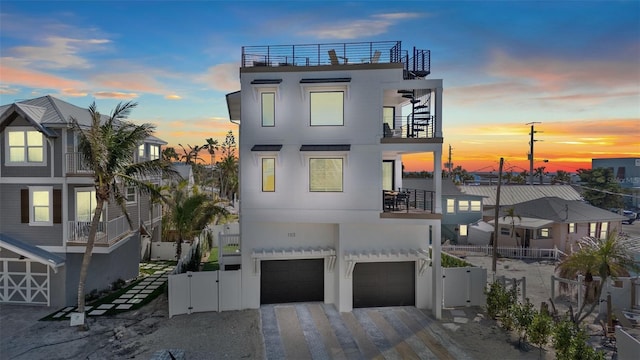103 4th St N Unit A, Bradenton Beach, FL 34217 - view of front facade with a balcony, a gate, and stucco siding