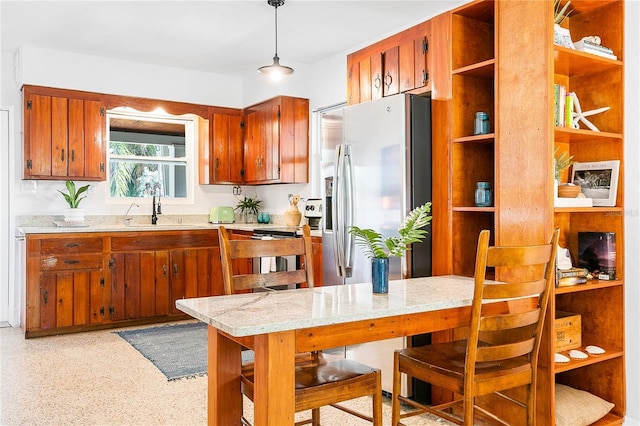 302 Pavonia Rd, Nokomis, FL 34275 - kitchen with a sink, stainless steel fridge, brown cabinetry, and open shelves