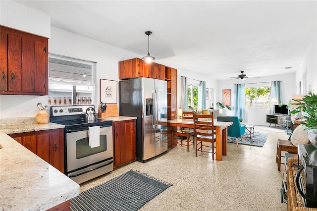302 Pavonia Rd, Nokomis, FL 34275 - kitchen featuring appliances with stainless steel finishes, dark aggregate flooring, a ceiling fan, decorative light fixtures, and open floor plan