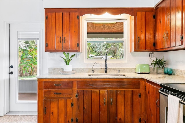 302 Pavonia Rd, Nokomis, FL 34275 - kitchen with a sink, plenty of natural light, and brown cabinets