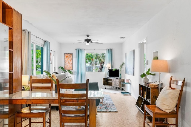 302 Pavonia Rd, Nokomis, FL 34275 - dining room featuring healthy amount of natural light, dark aggregate flooring, and a ceiling fan