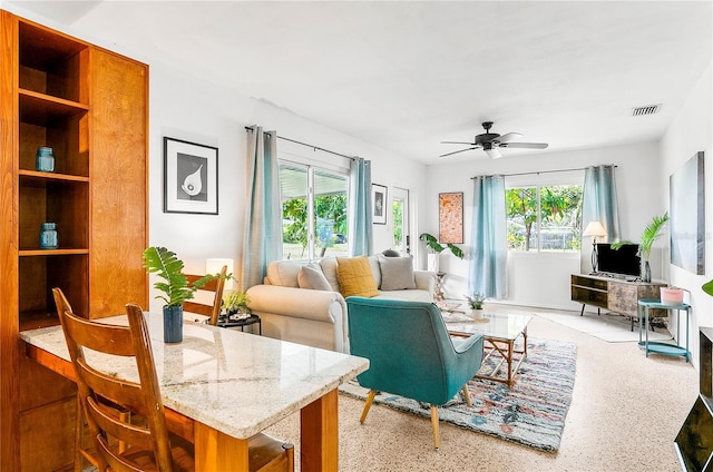 302 Pavonia Rd, Nokomis, FL 34275 - living room with healthy amount of natural light, a ceiling fan, and speckle patterned floor