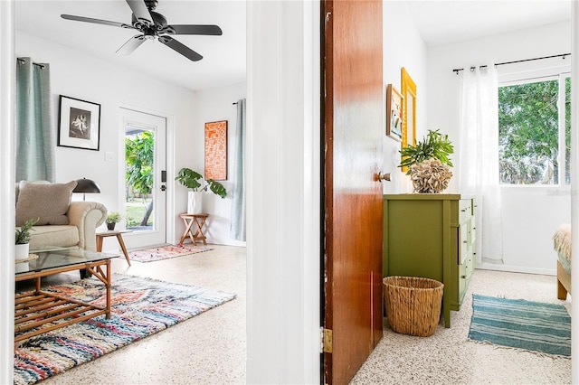 302 Pavonia Rd, Nokomis, FL 34275 - living area featuring speckle patterned floor, plenty of natural light, and a ceiling fan