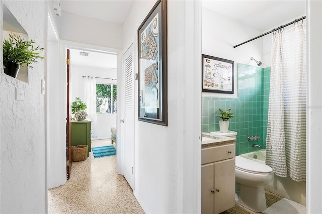302 Pavonia Rd, Nokomis, FL 34275 - full bathroom with shower / bath combo, vanity, toilet, tile walls, and speckled floor