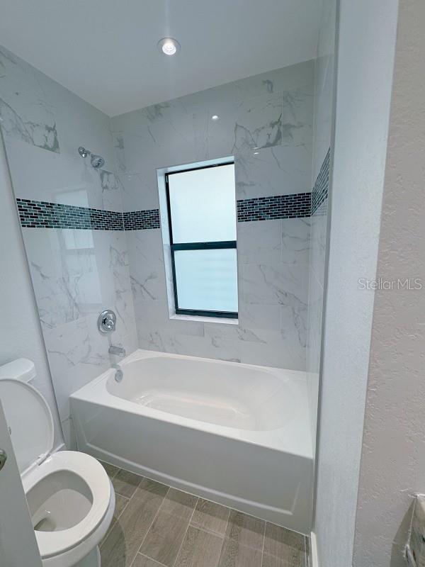 3398 Escobar Ln, North Port, FL 34286 - full bathroom with toilet and shower / bathtub combination