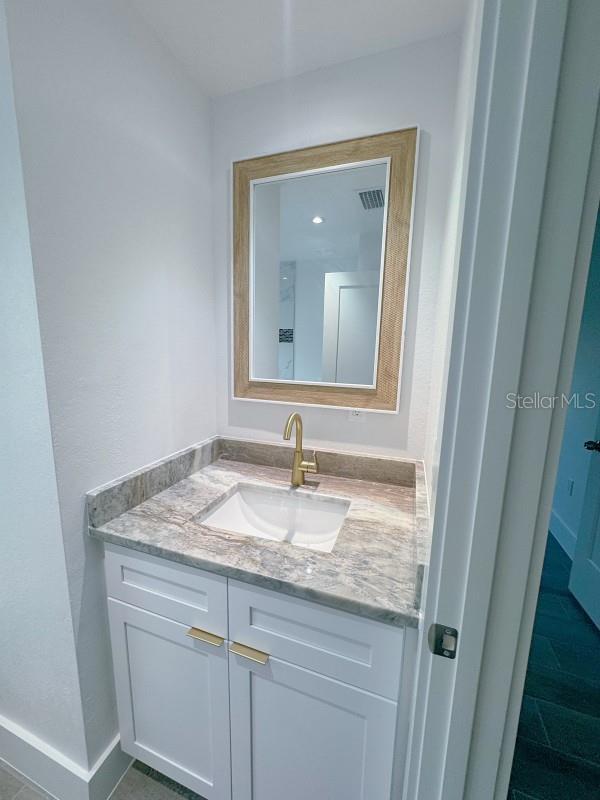 3398 Escobar Ln, North Port, FL 34286 - bathroom with vanity and baseboards